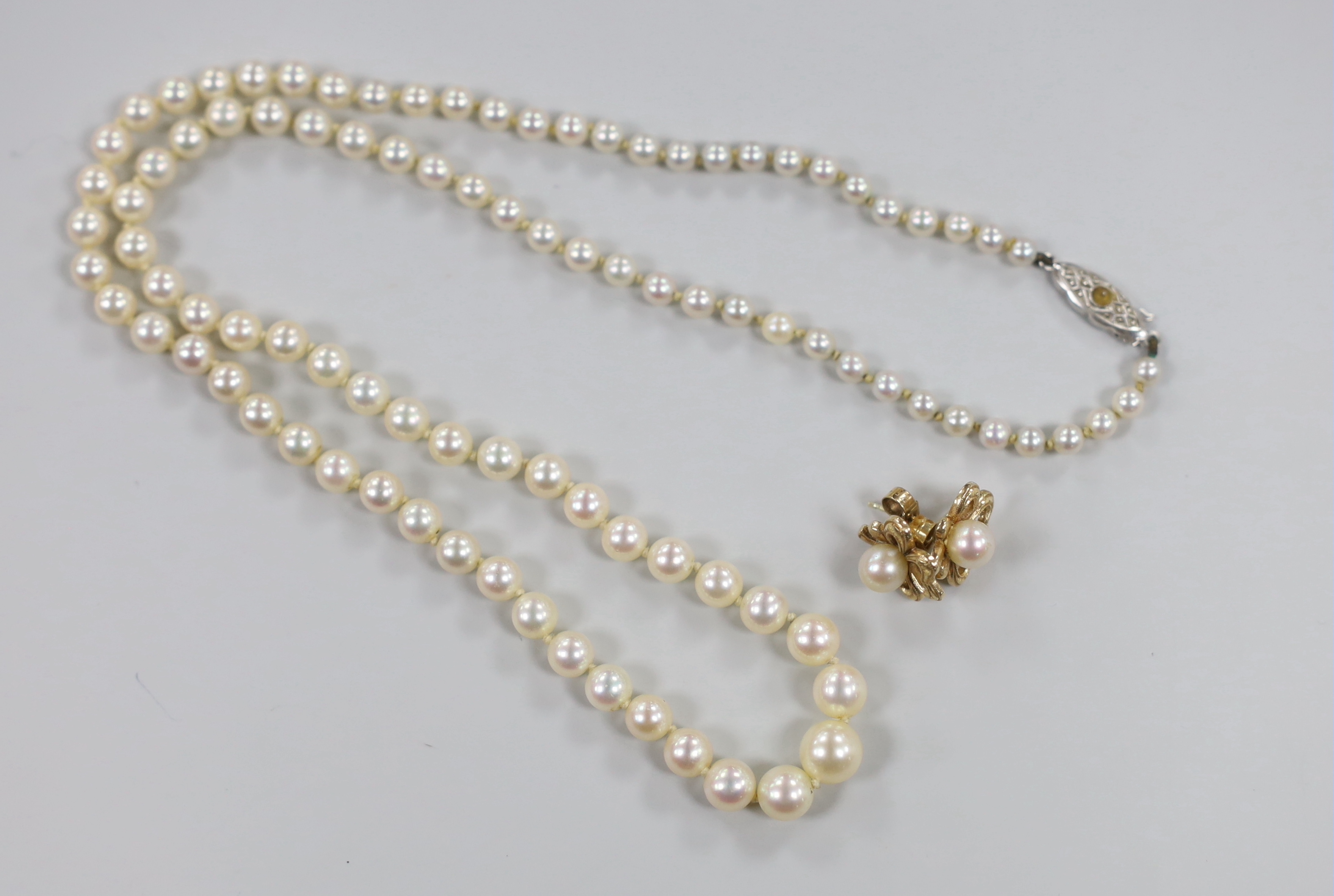 A single strand graduated cultured pearl necklace with 9ct clasp, 50cm and a pair of 375 and cultured pearl ear studs.